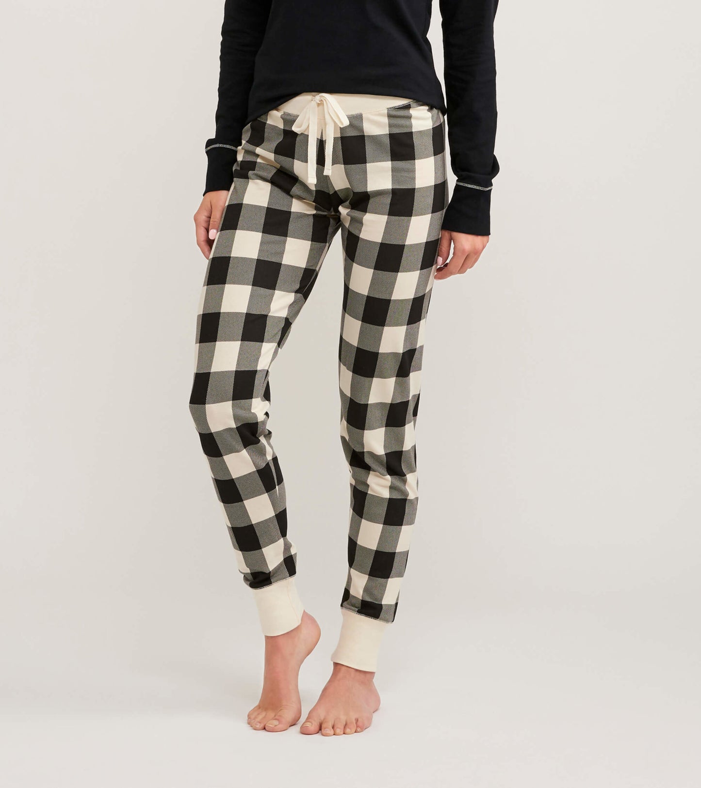 Cream plaid women's sleep leggings with a drawstring waist and fitted cuffs, ideal for lounging or sleeping.
