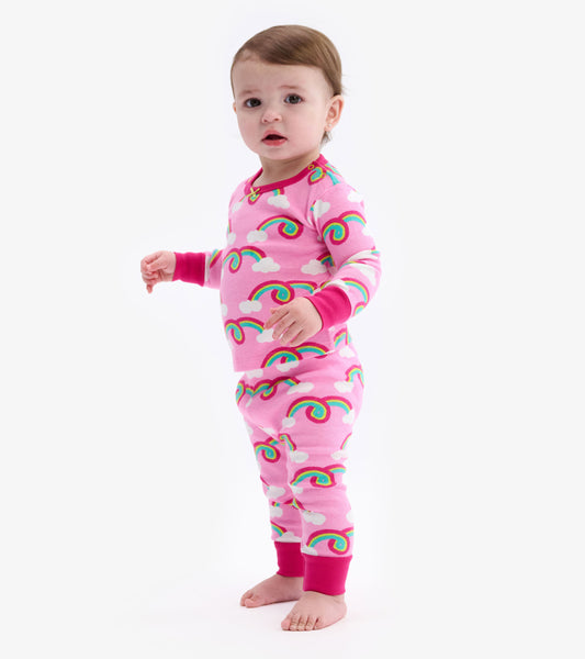 Pink baby pajama set featuring colorful rainbows and clouds, with long sleeves and pants, suitable for infants.