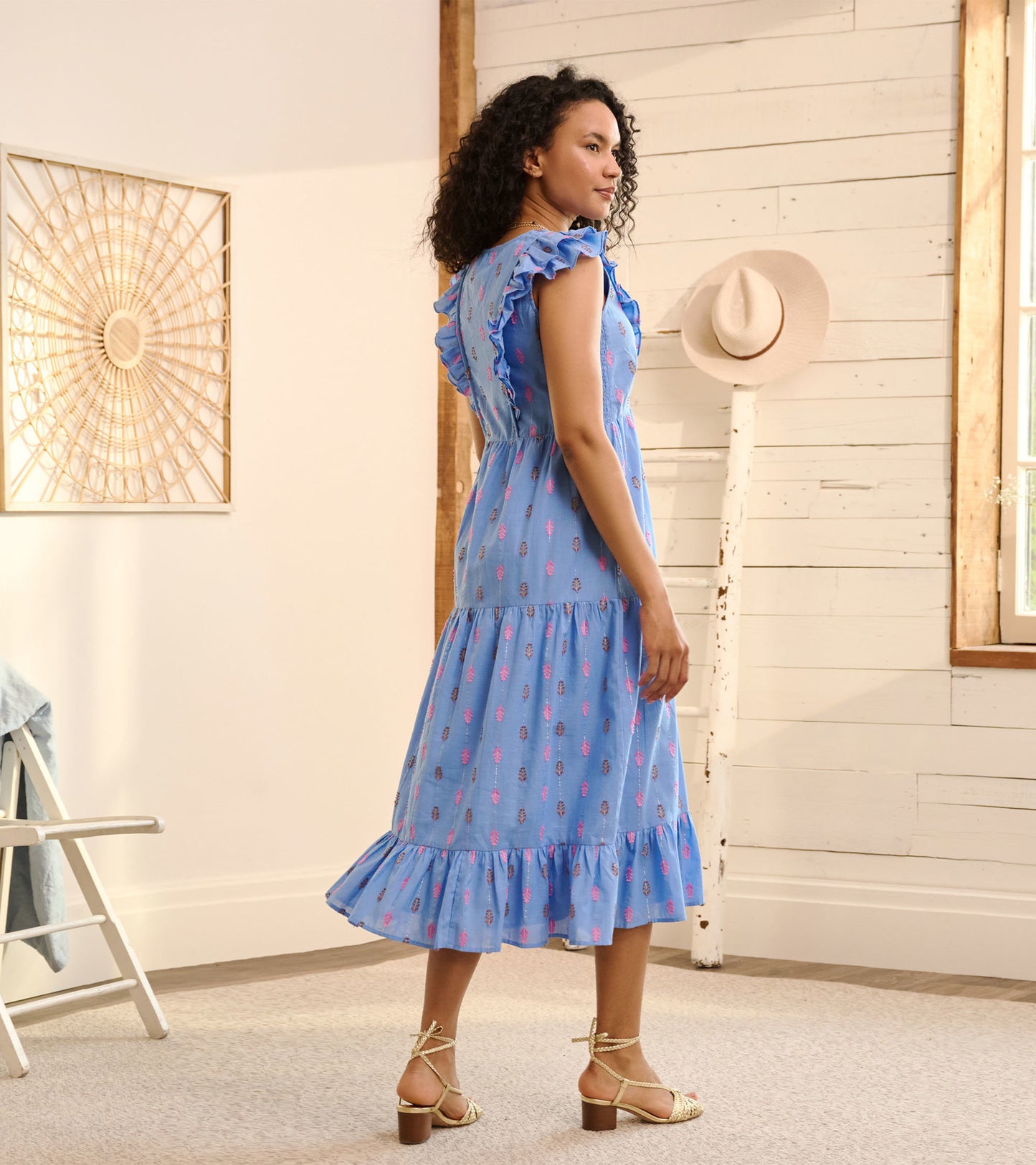 Blue midi dress with ruffled sleeves and a tiered hem, featuring a rainbow feather pattern.