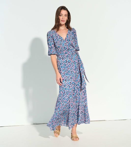 Maxi dress featuring a vibrant sundial mandala pattern in blue and pink, with a wrap design and puff sleeves.