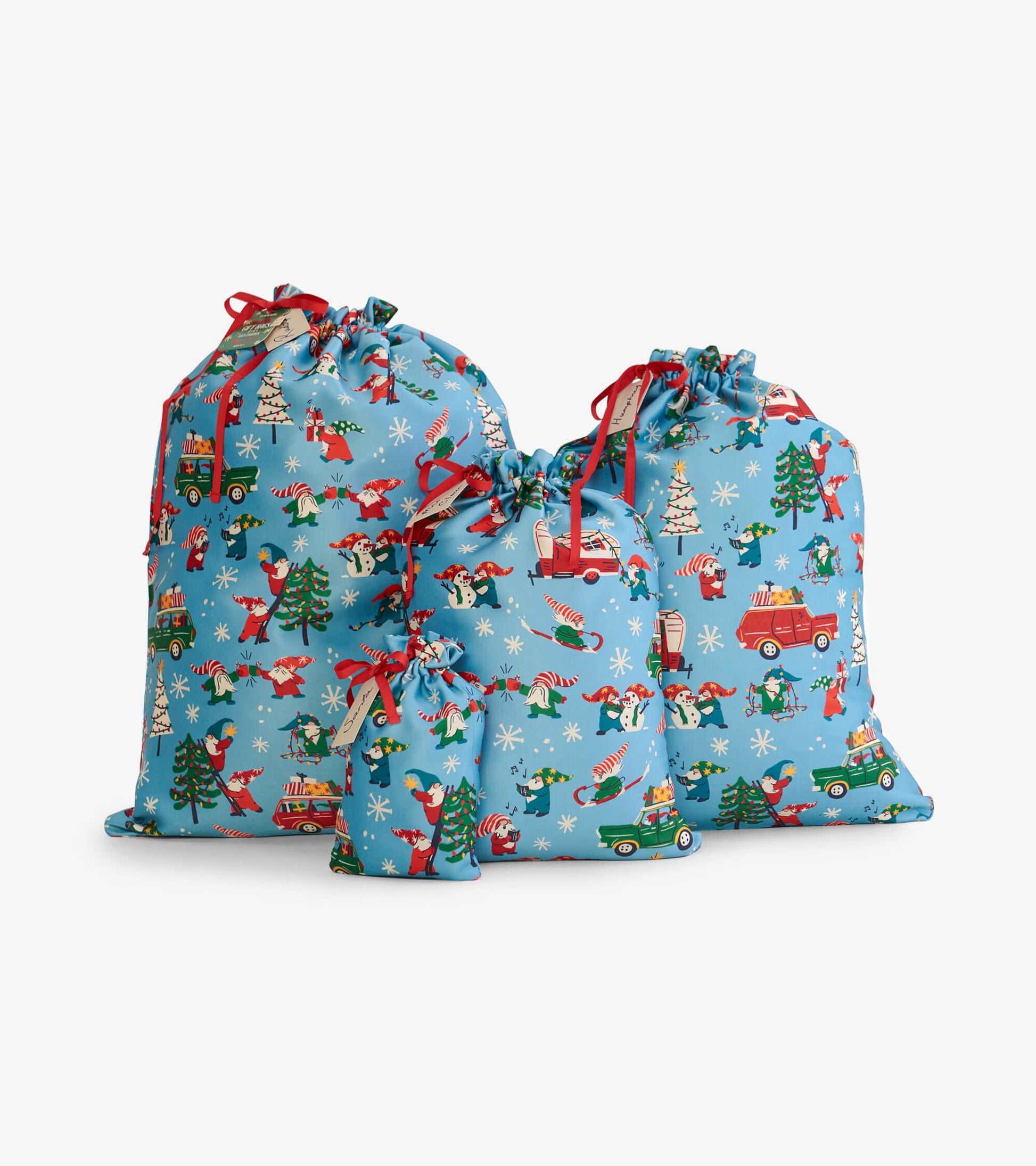Set of three reusable gift bags in blue with festive gnome and holiday patterns, featuring drawstring closures.