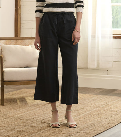 Caviar linen tie front pants with a relaxed fit and wide legs, styled with a striped sweater and sandals.