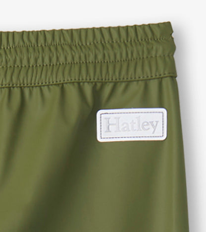 Forest green kids' rain pants with an elastic waistband and a small logo patch. Ideal for wet weather play.