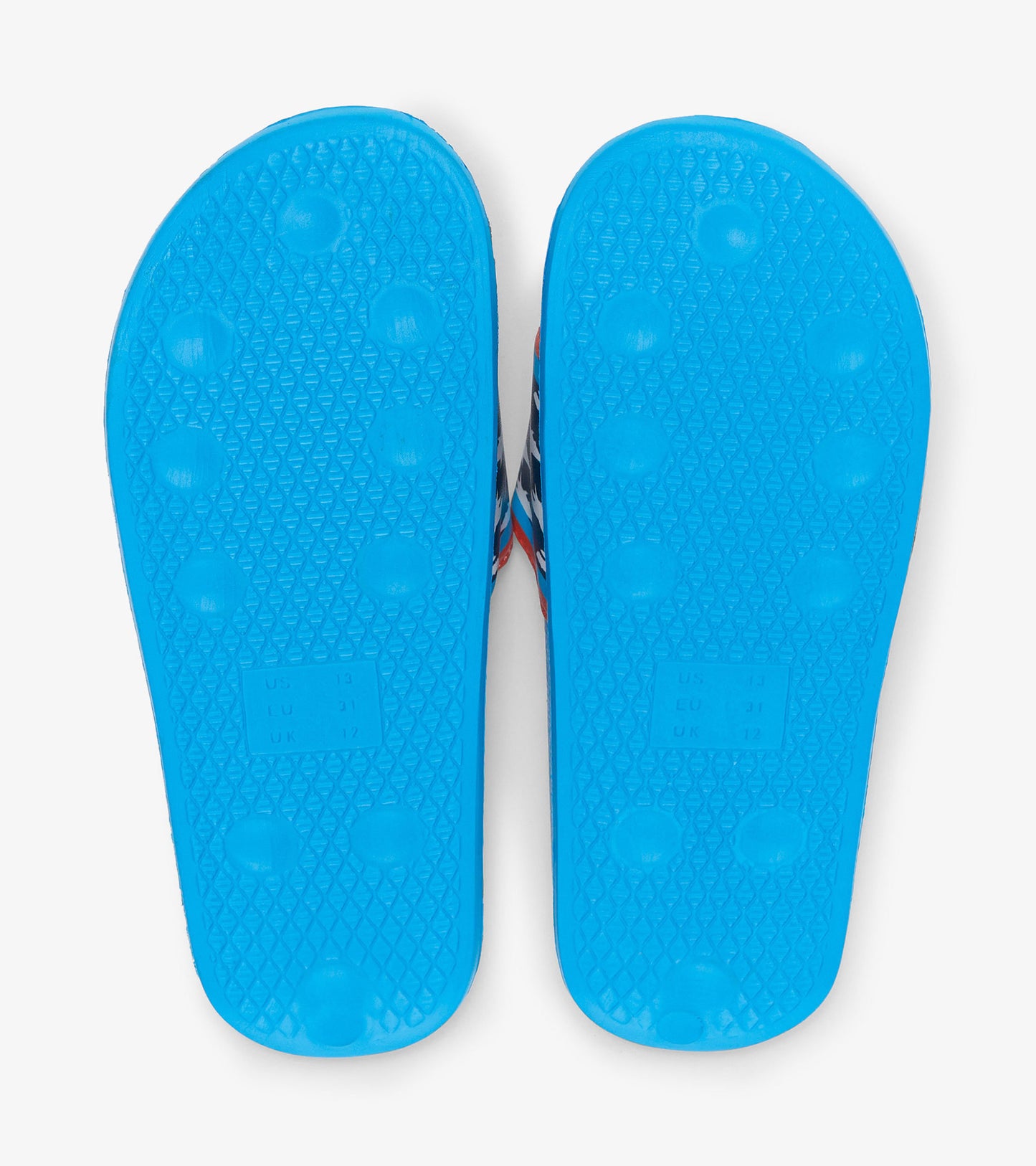 Blue rubber slides featuring a textured sole and a colorful shark print on the upper.