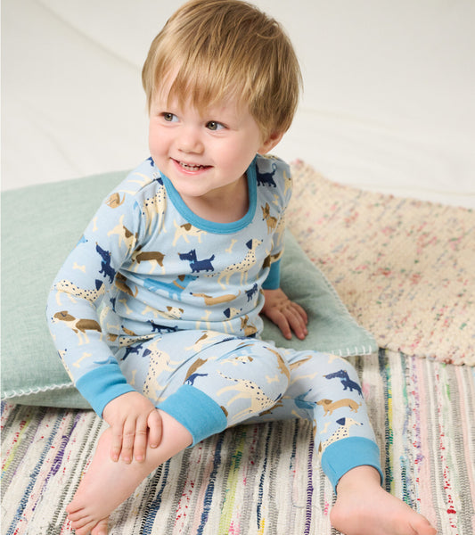 Light blue baby pajama set featuring playful dog patterns, with long sleeves and pants, suitable for infants.