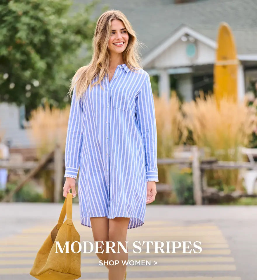 Shop women's modern striped styles. Showing woman wearing a blue and white striped shirtdress outdoors with a tote bag.